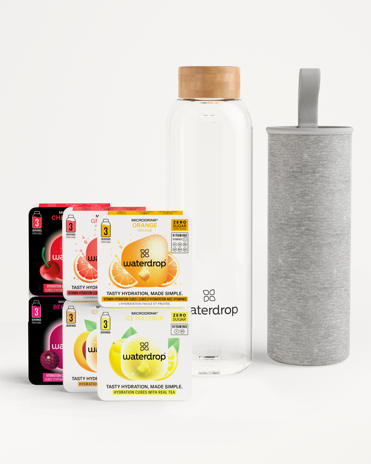 Starter Set Glass: Vier blisterverpakkingen Waterdrop Microdrink smaken (Orange, Ice Tea Lemon, Cherry Kiss, Berry en Grapefruit) met een slanke glazen waterfles, houten dop en grijze hoes voor isolatie.