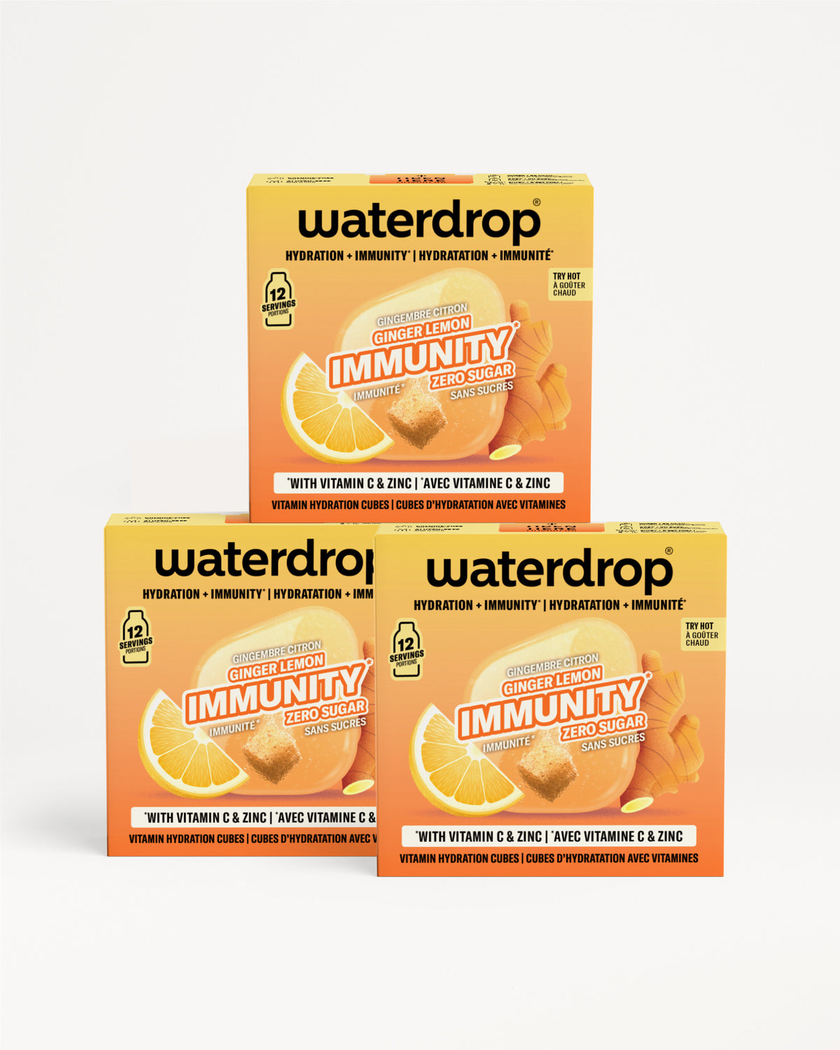Drie oranje Waterdrop-immunity dozen met vitamine C en zink, gestapeld in een piramide.