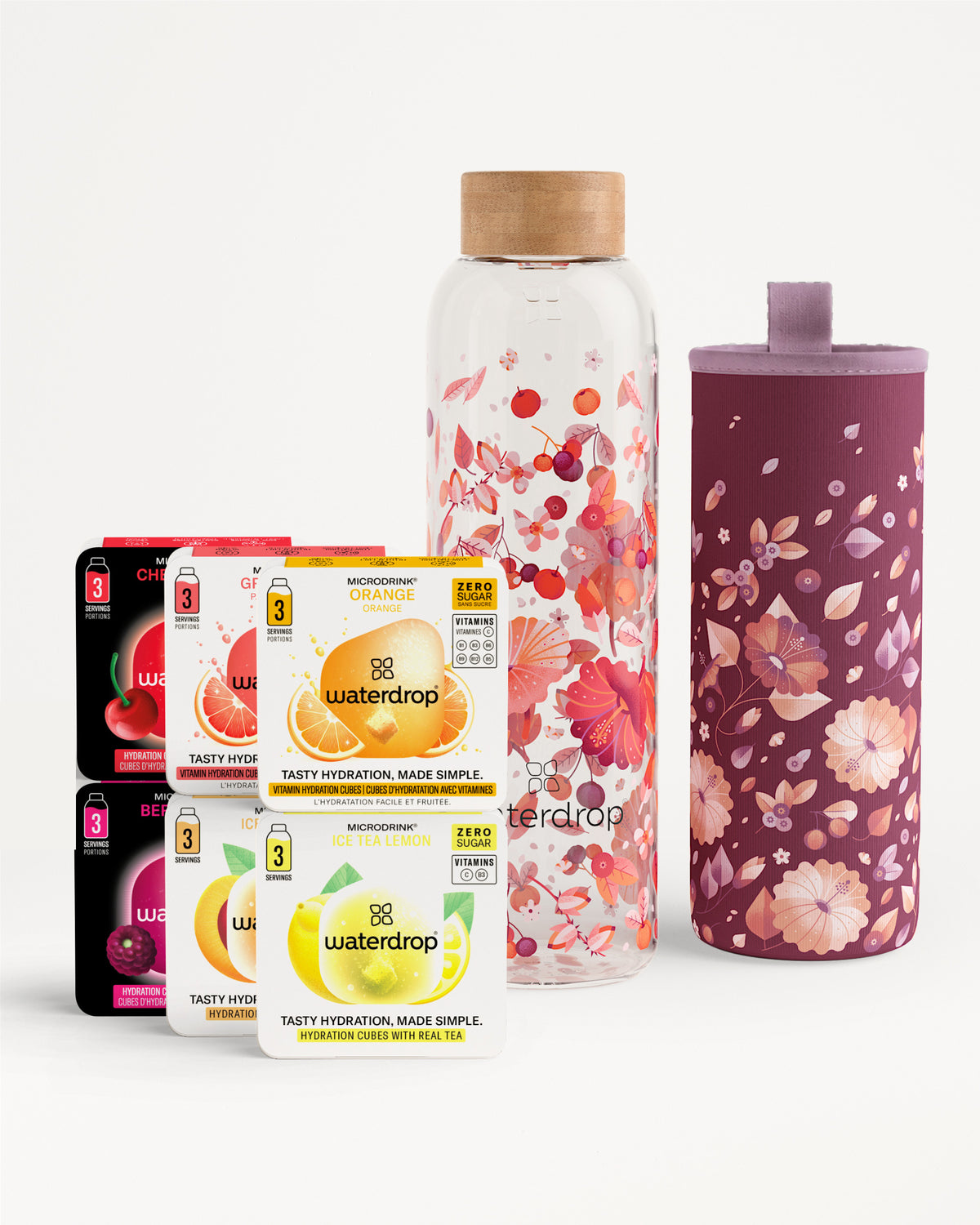 Gevarieerde Waterdrop-smaaktabletten dozen met een bloemige glazen fles en een bijpassende bloemige hoes.
