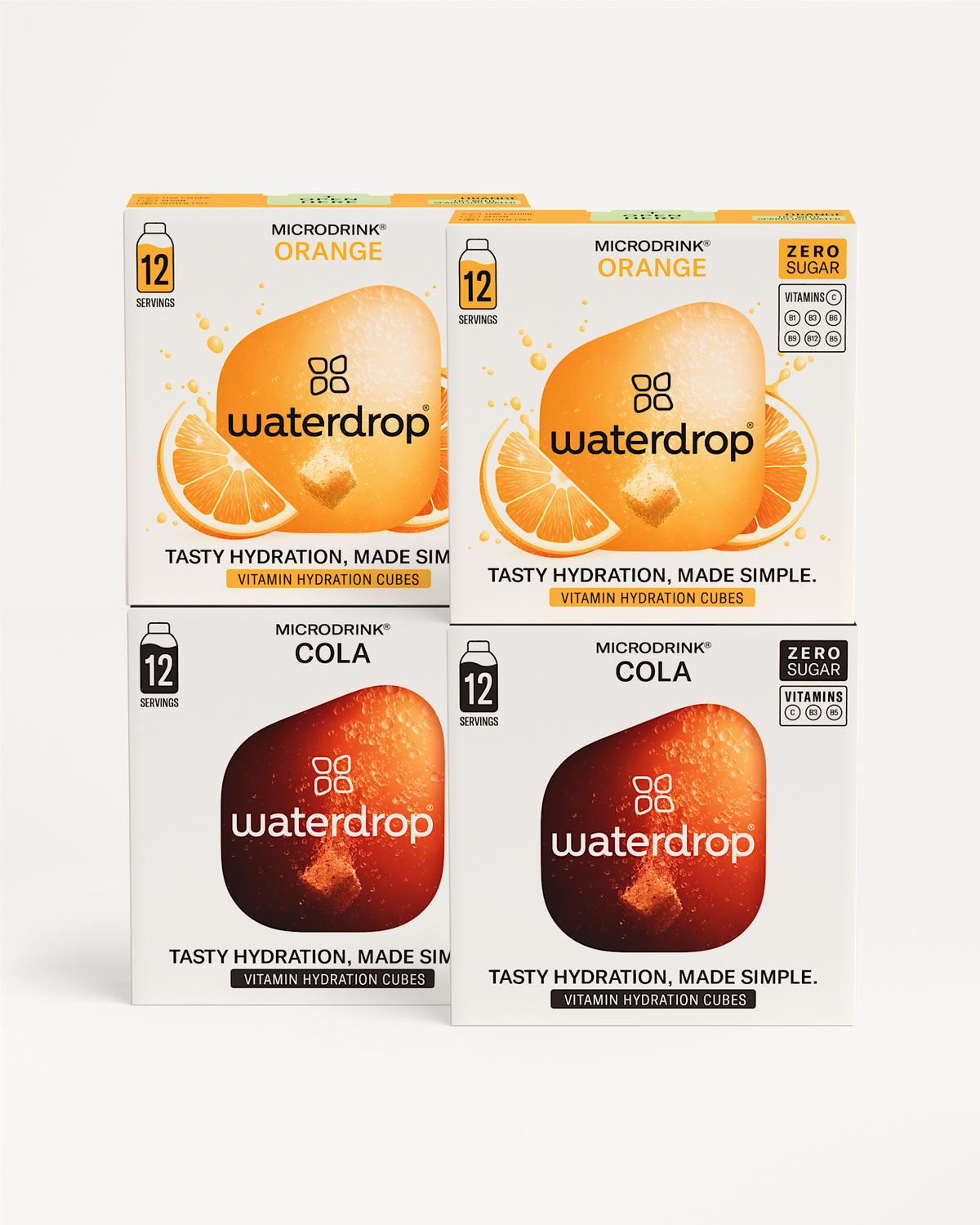 Vier kartonnen dozen met waterdrop® Microdrink Cola Orange Set 3+1. Twee dozen Cola en twee Orange, elk met 12 porties, vitaminen (C, B1, B2, B3, B5, B6, B12), zonder suiker.