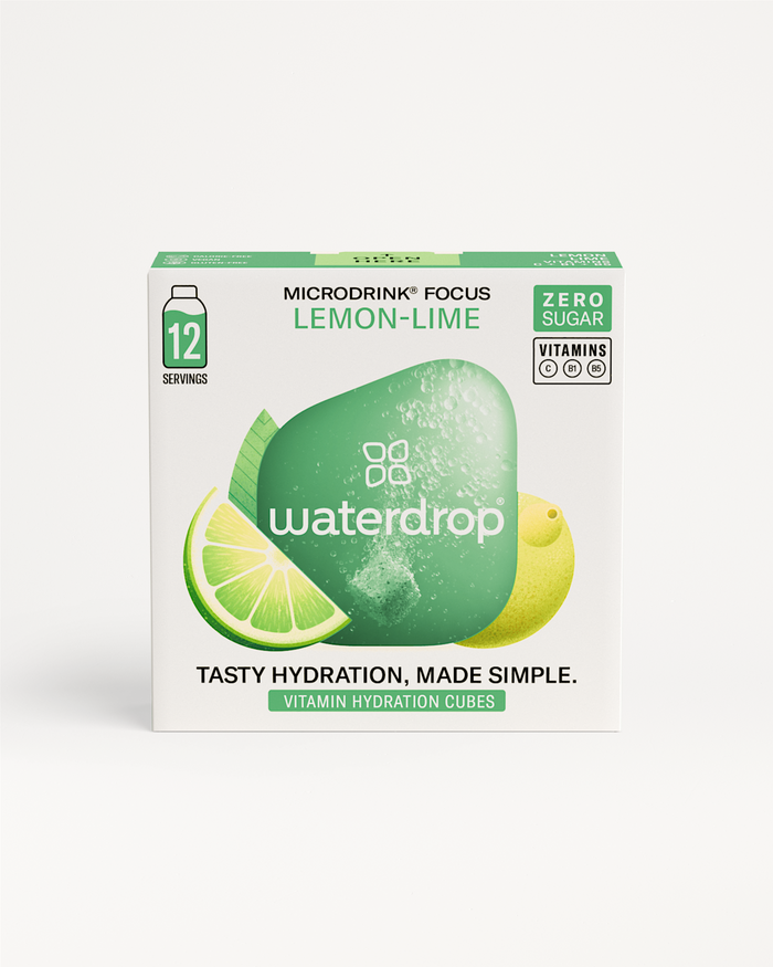 Retailverpakking van Waterdrop Microdrinks CITROEN-LIMOEN/FROSTED LIME toont “Microdrink® Focus Lemon-Lime”, “Zero Sugar”, “Vitamins C, B1, B5”, “12 Servings”. Stijlvolle citroen-limoen visuals benadrukken suikervrije hydratatie.