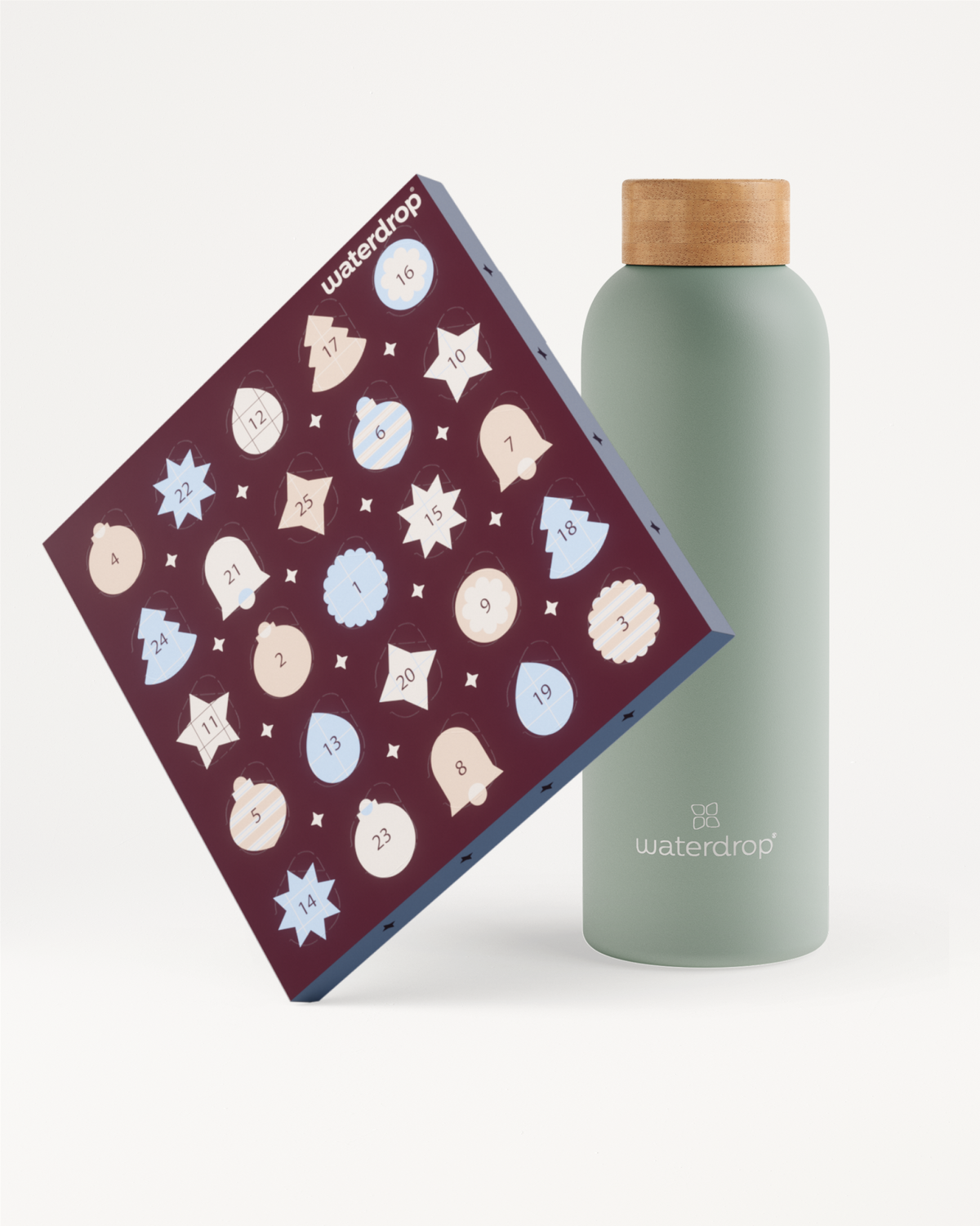 Schuin staande donkerpaarse doos met tal van lichte ronde pictogrammen naast een lichtgroene fles met houten dop.
