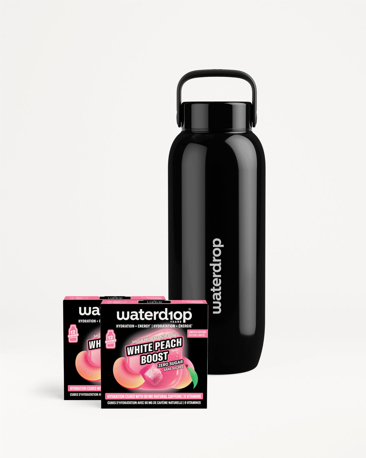 Zwarte roestvrijstalen herbruikbare waterfles met draaggreep, naast twee kleine smaakdoosjes.