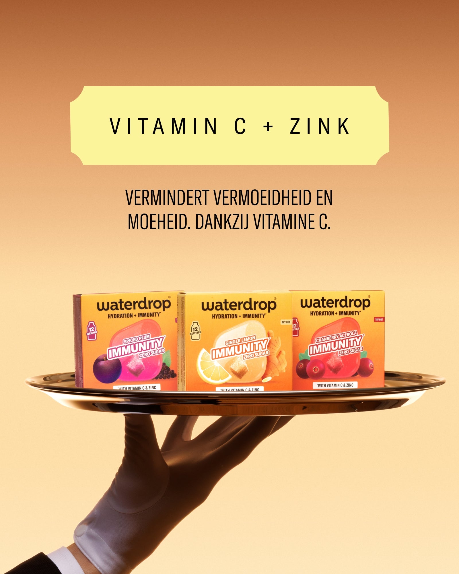 Waterdrop Vitamin C + Zinc pakjes op een schotel, vastgehouden door een met handschoenen bediende hand, oranje achtergrond.