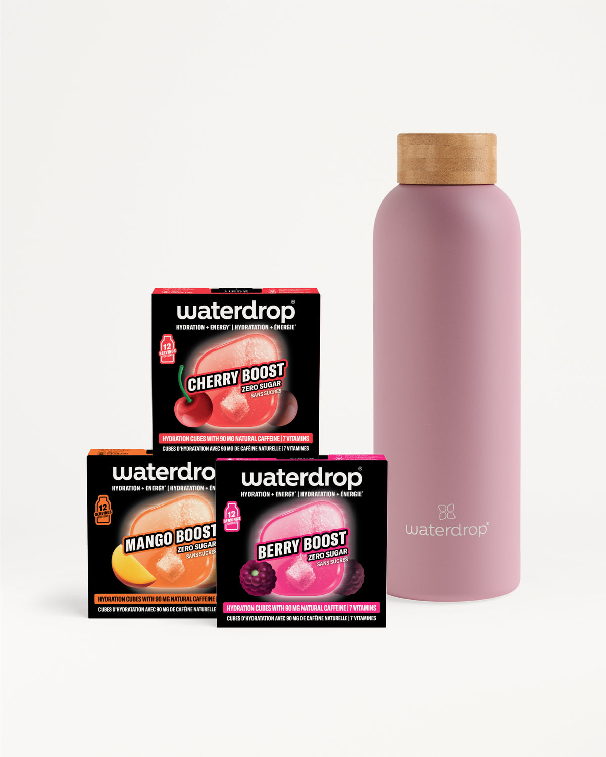 Drie Flavor-Boost-boxen en een roze herbruikbare fles met houten dop.